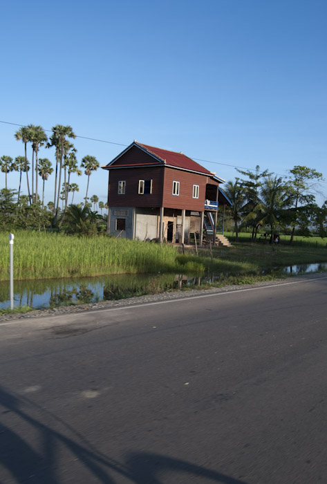 red-roofed building in field